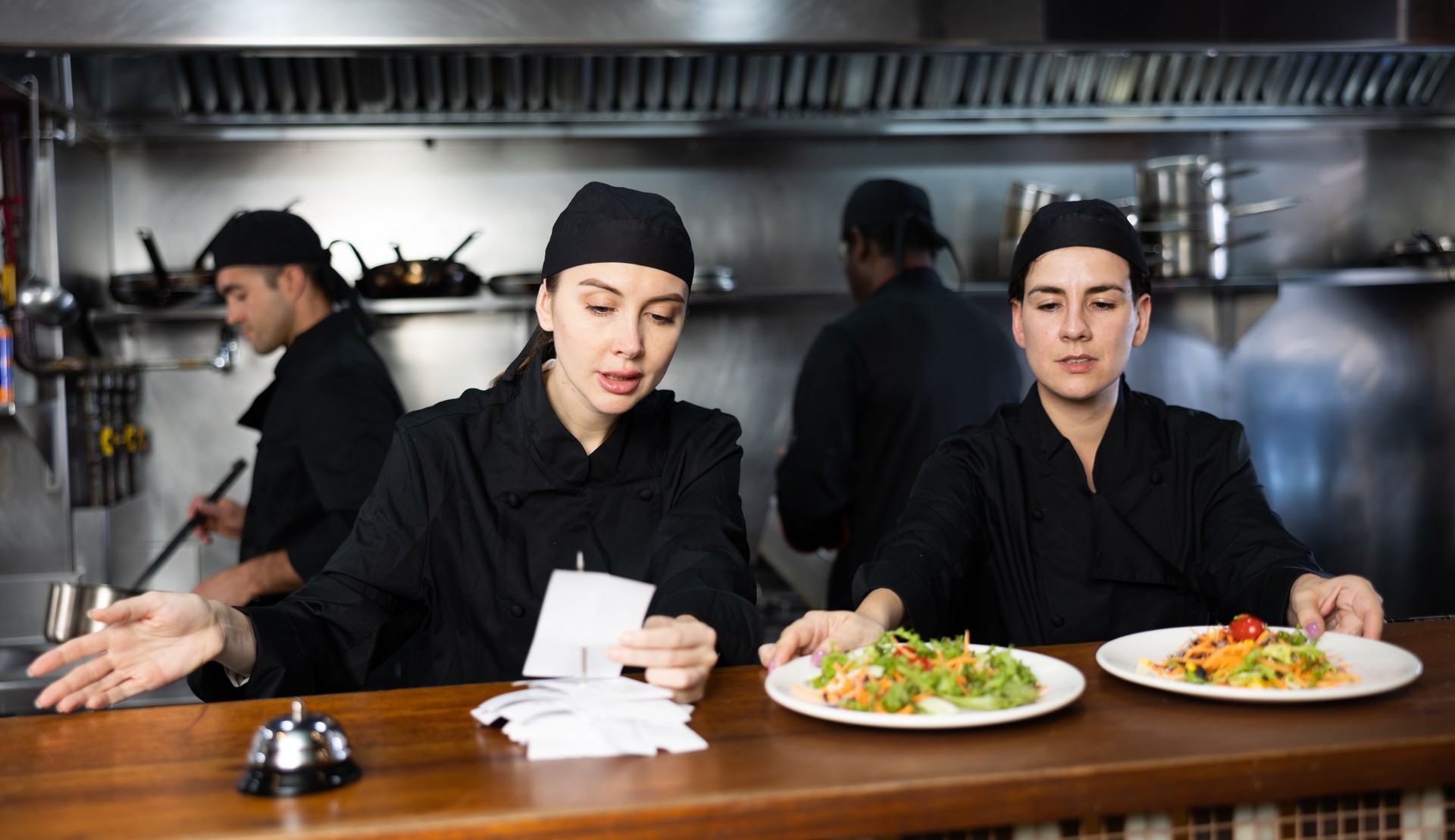 Chefs checking orders and giving out meals